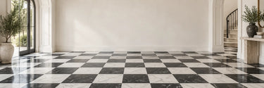 Black and white marble checkerboard tile floor in a bright entryway