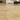 18x18 filled and honed gold yellow travertine tiles installed on a floor in a close-up interior application