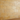 3x6 tumbled gold yellow travertine tiles installed on a wall in a horizontal subway pattern