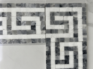Thassos white marble Greek Key corner with blue-gray dots