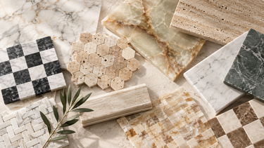 Natural stone tile and mosaic collection featuring marble, travertine, onyx, checkerboard patterns, hexagon mosaics, and decorative stone tiles in neutral, cream, gray, and warm beige tones.