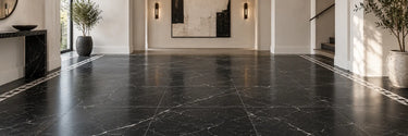 Nero Marquina black marble floor tile with a contrasting mosaic border