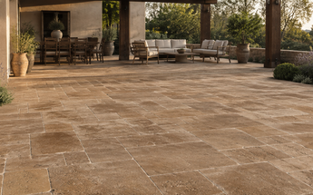 Noce Travertine pavers installed across a spacious landscaped outdoor living terrace.