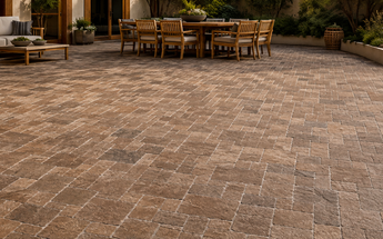 Walnut Travertine three-piece Mini Versailles mosaic installed across a spacious landscaped backyard patio.