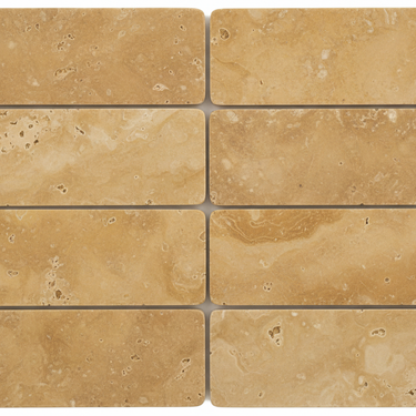 Eight horizontal 3x6 tumbled gold yellow travertine tiles arranged in a 4x2 layout