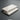 Two rectangular white marble-look tiles stacked slightly offset on a dark gray background, with a small label at the bottom reading 'White Pearl Turkish Marble 3mm'.