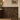Emperador Dark crown molding separating dark marble tile and wallpaper in a bathroom