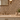 Installed-view of Emperador Dark lattice mosaic with Crema Marfil diagonal inlays on a bathroom vanity wall.