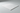 Close-up side angle showing the micro-beveled edge, surface, and thickness of an 18x18 Bianco Carrara white marble tile