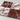 Side-angle view showing the edges and thickness of alternating Rosso Laguna and Calacatta Viola marble tiles