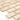 Close-up of ivory travertine 2x4 deep-beveled brick mosaic tile showing chamfered edges and honed finish