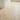 Bathroom floor with ivory travertine 1x2 herringbone mosaic tiles in classic zigzag pattern
